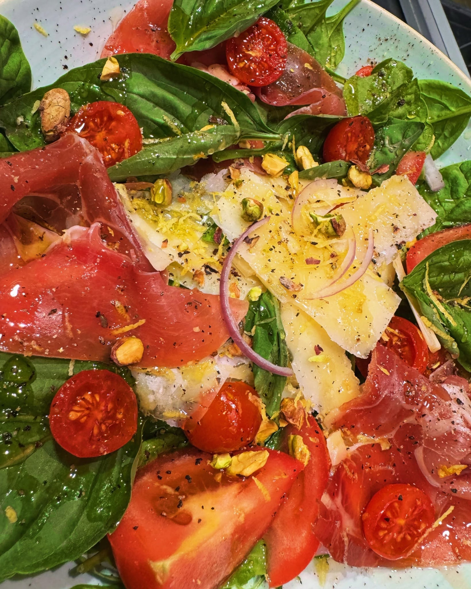 Italian salad with cured meat, tomatoes, basil and shaved cheese